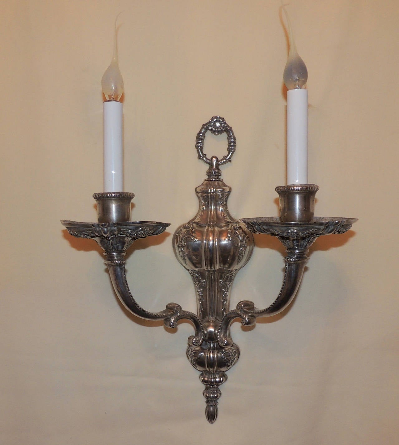 If you love intricate details, these marked Caldwell sconces will fulfill that wish. Beautiful floral detail starts at the ring at the top and continues throughout the center body of these two-arm sconces. The floral detail continues up the curved