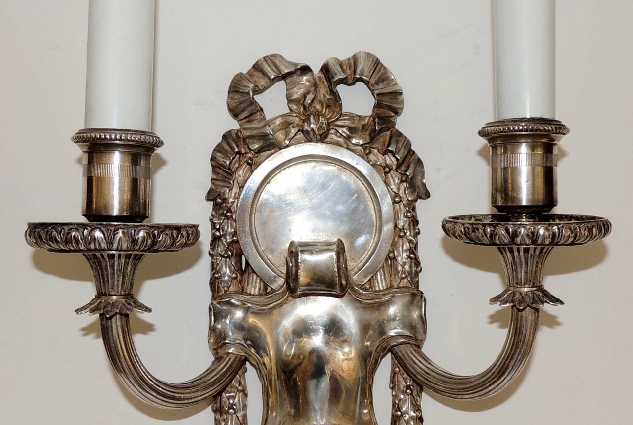 Early 20th Century Elegant Pair of E.F. Caldwell Silvered Bronze Two-Arm Neoclassical Bow Sconces