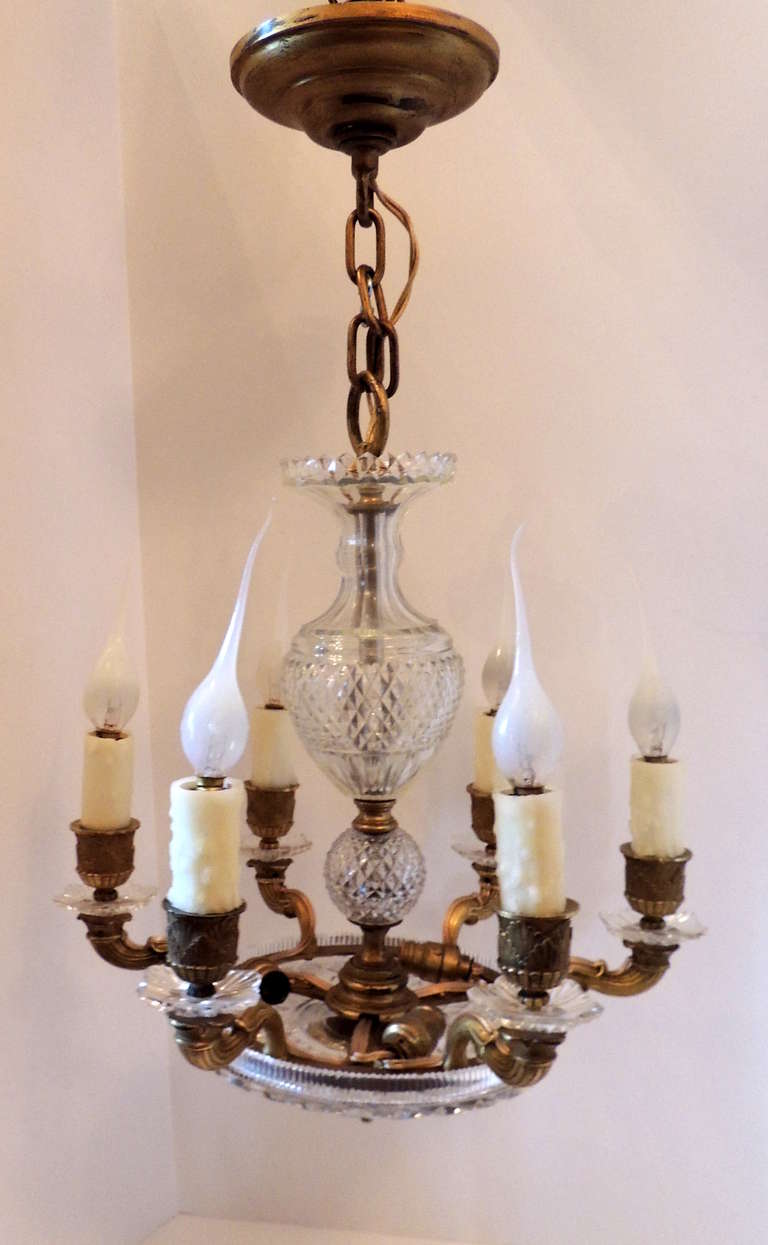 This is a petite doré bronze and delicate cut crystal six-arm with three interior lights, perfect for the dressing area or that small place that still needs a good light.

Measures: 16 H x 14 W.