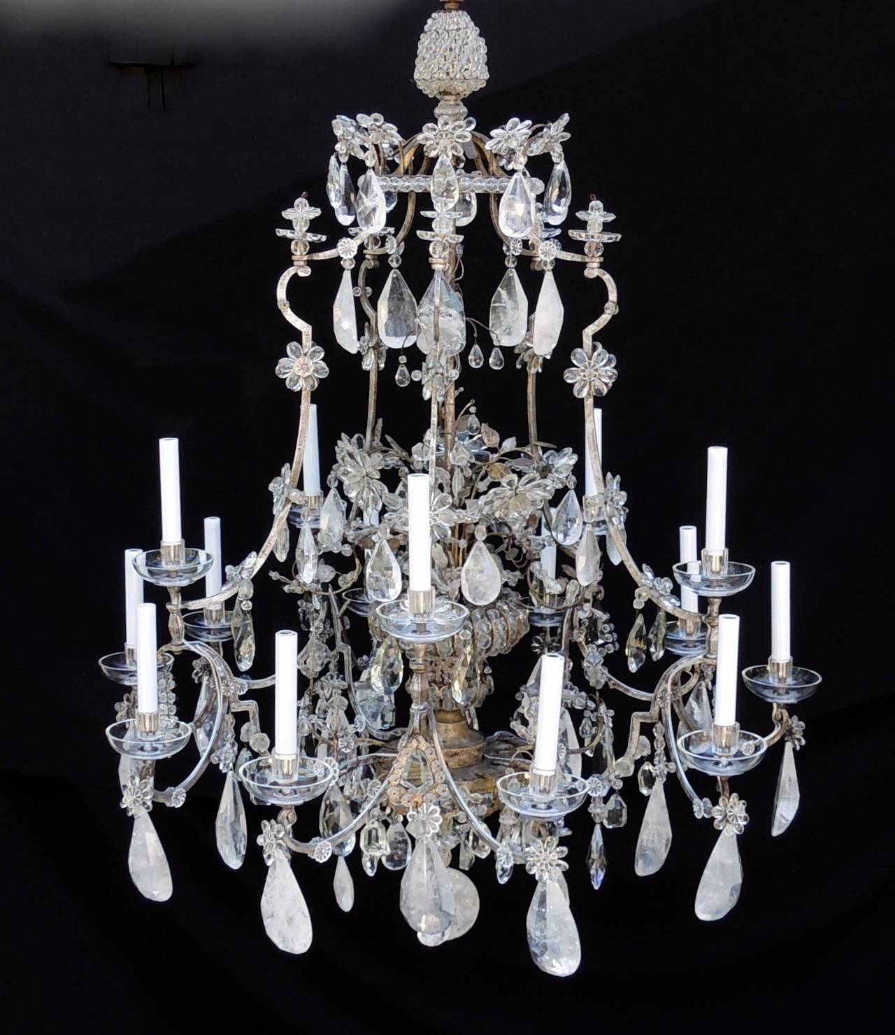 This incredible original 1920s, Maison Baguès silvered gilt chandelier has fifteen-lights on two-tiers surrounding a crystal beaded urn centre. The top is decorated with a full crystal beaded acorn, a beaded trimmed crown with crystal flowers and