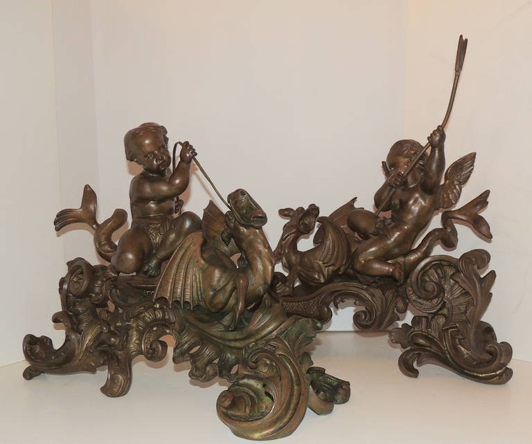 A Museum Quality Pair of French Bronze Cherubs Riding Winged Dragons Chenets