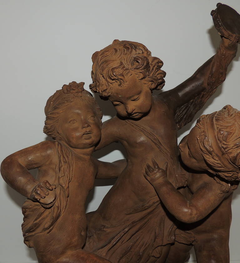 Italian sculpture, Fernando Cian (Ciancianaini 1889-1954) signed terracotta statue of three children at play. One is holding a tambourine, the others each have a cookie. The faces are endearing and the details in this piece, note the hair and curls,