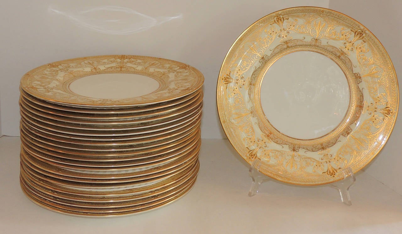 Perfect for the large gatherings, vintage set of  24 Royal Worcester gold encrusted rim dinner plates on ivory china.

Marked with Royal Worcester Trademark
#1705 in hand painted red 

6W BA in the porcelain