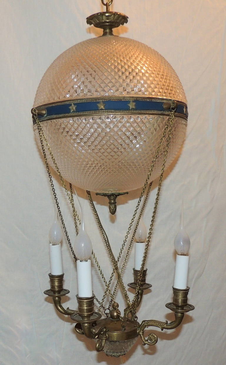 This endearing French hot air balloon chandelier with four interior lights and four arms is sure to add a special panache to your room. This light is  approximately 24