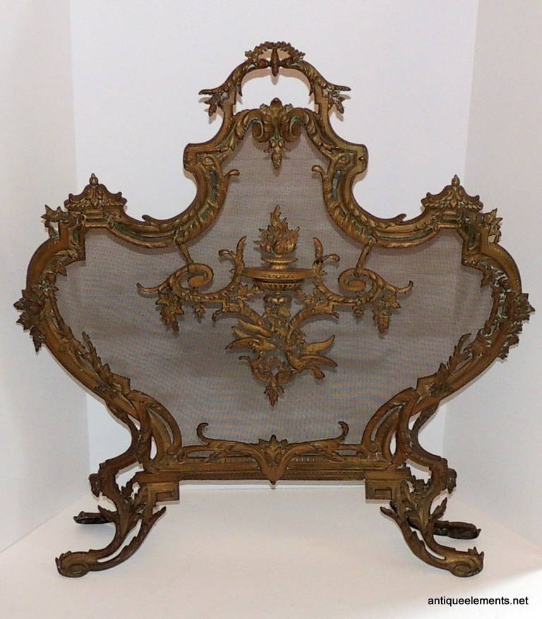 The bronze work on this fine fire place screen will make that wonderful statement in your room that says beautiful. The delicate urn filled with flames, surrounded by floral and scroll work flourish that are finished with the birds in flight at the