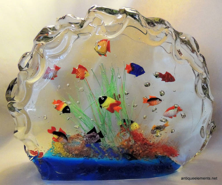 Murano Glass Aquarium Glass Fish Sculpture has 13 inhabitants in the beautiful sea world created by famed Murano Glass makers of Italy. The vivid colors are sure to add to the décor of any space you place this wonderful piece in. 

10.5