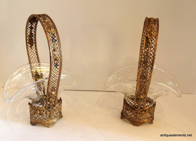 This sweet pair of bronze baskets are decorated with roses across the 1