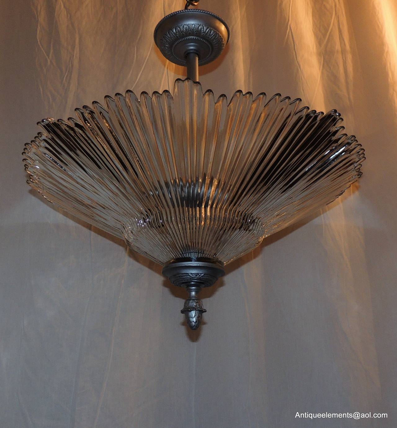 This wonderful Large Art deco style silvered gilt star chandelier with clear pleated glass has two interior lights. The beautiful pleated glass will disperse a wonderful light in your room.
Height is adjustable, if need be taller or