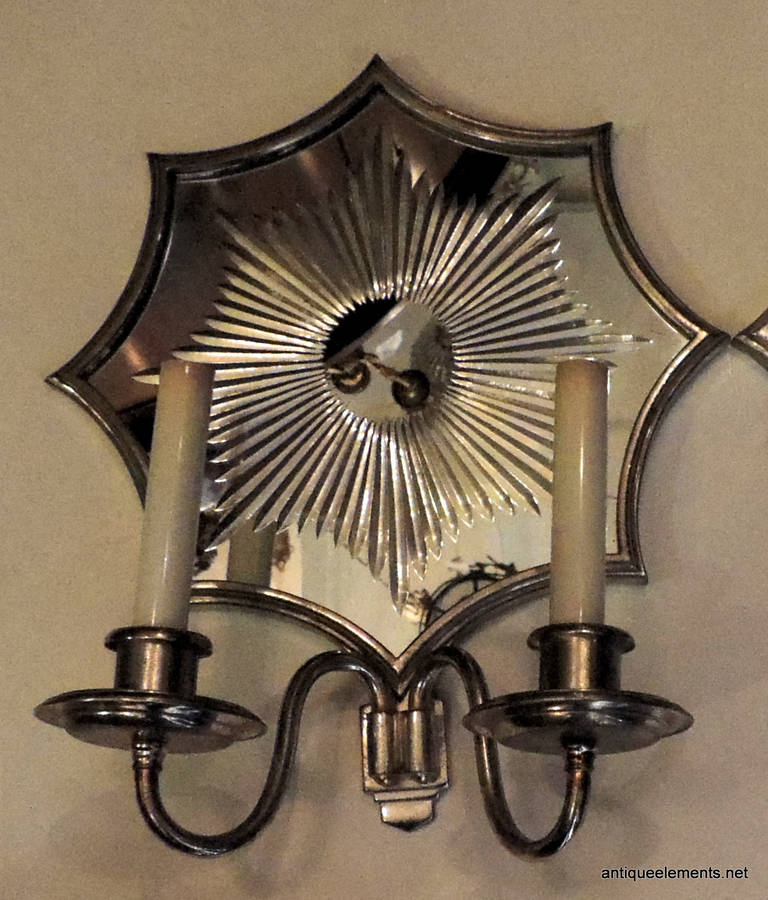 These beautiful pair of two armed sconces signed by Art Deco E. F. Caldwell in silvered bronze with wonderful vintage starburst mirror is sure to make a wonderful addition to your décor. The stars are 12
