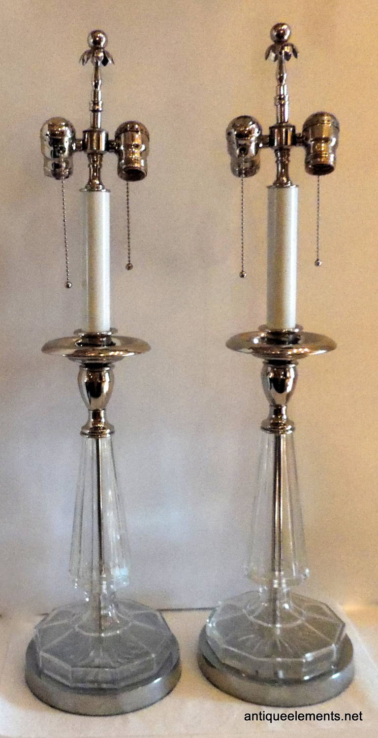 Perfect for a transitional or classic room, this pair of silvered and crystal lamps with decorative finials are 29