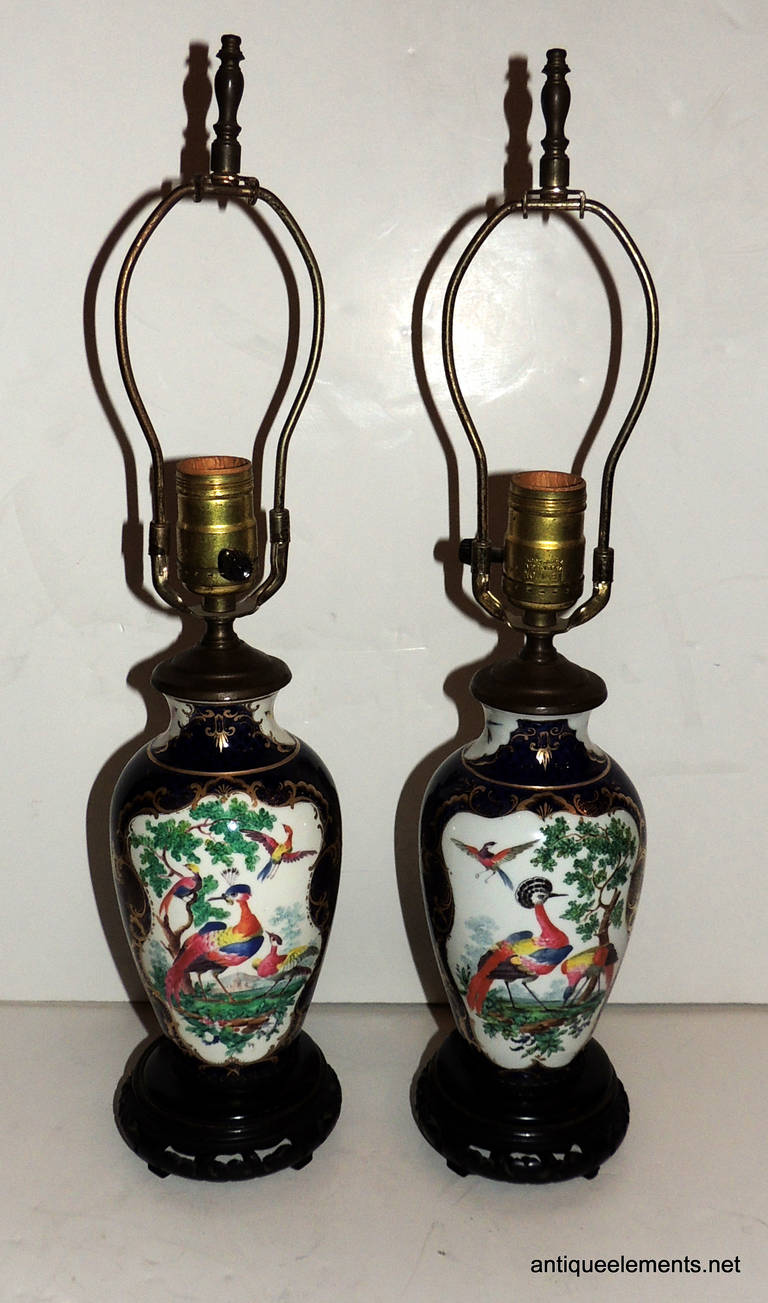 The delicate detailed hand painting done on this pair of porcelain chinoiserie lamps is that beautiful touch of color for your tables. A majestic blue with detailed painting that is highlighted in the pictures. Four different panels of beautiful