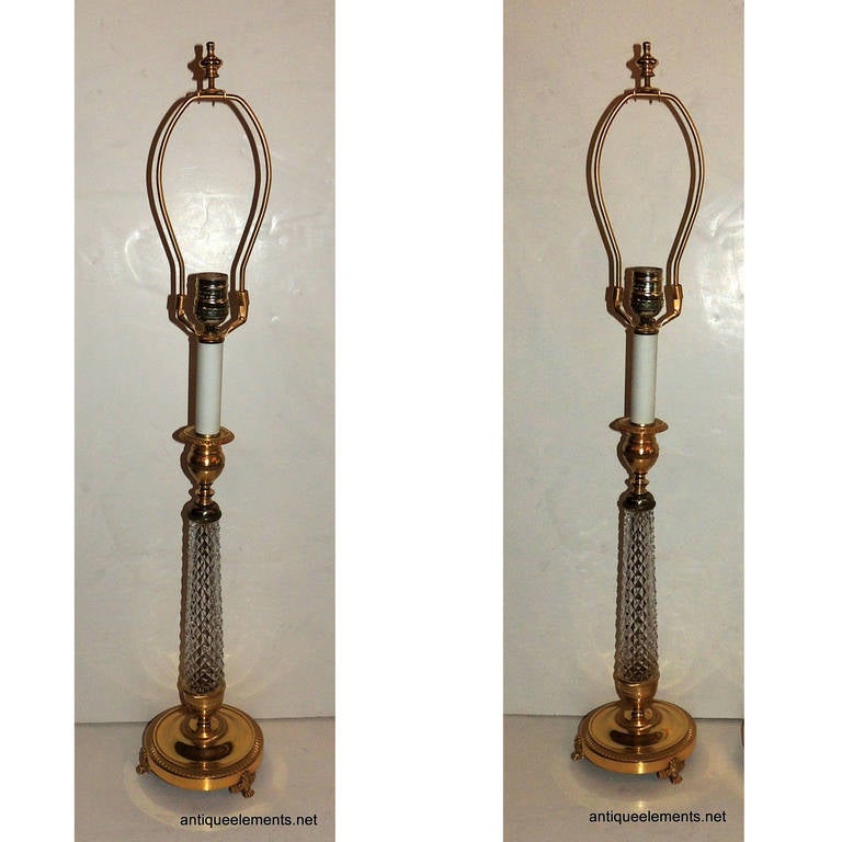 This wonderful pair of Classic candlestick style doré bronze and cut crystal lamps works for your transitional or modern style decor. The height is 31" to the top of the finial on a 5" base. The bronze is embellished with detail engraving