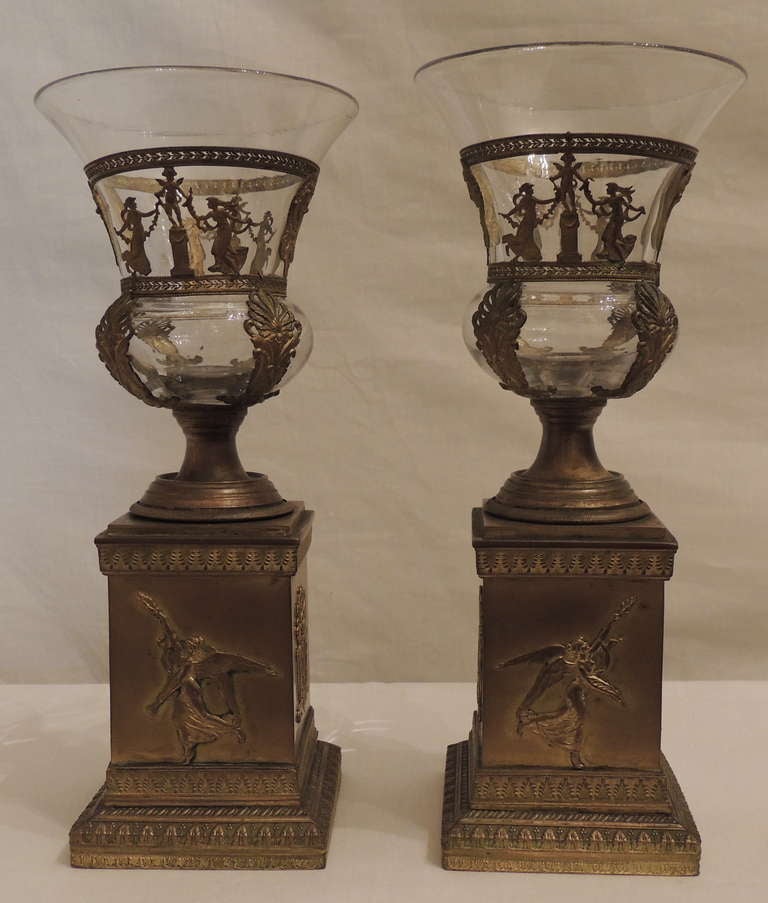 Pair of lovely French empire style bronze and glass urns. Please note, they are blown glass and one is slightly higher than the other. The base measures 3