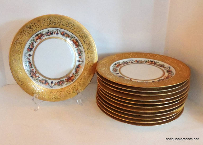 These elegant 10.75" dinner plates are a wonderful way to show off your holiday table. Made by Hutschenreuther Black Knight, sold by Ovington's, the gold encrusted band is 1.5" wide on the edge and the inner area decorated with fruit,