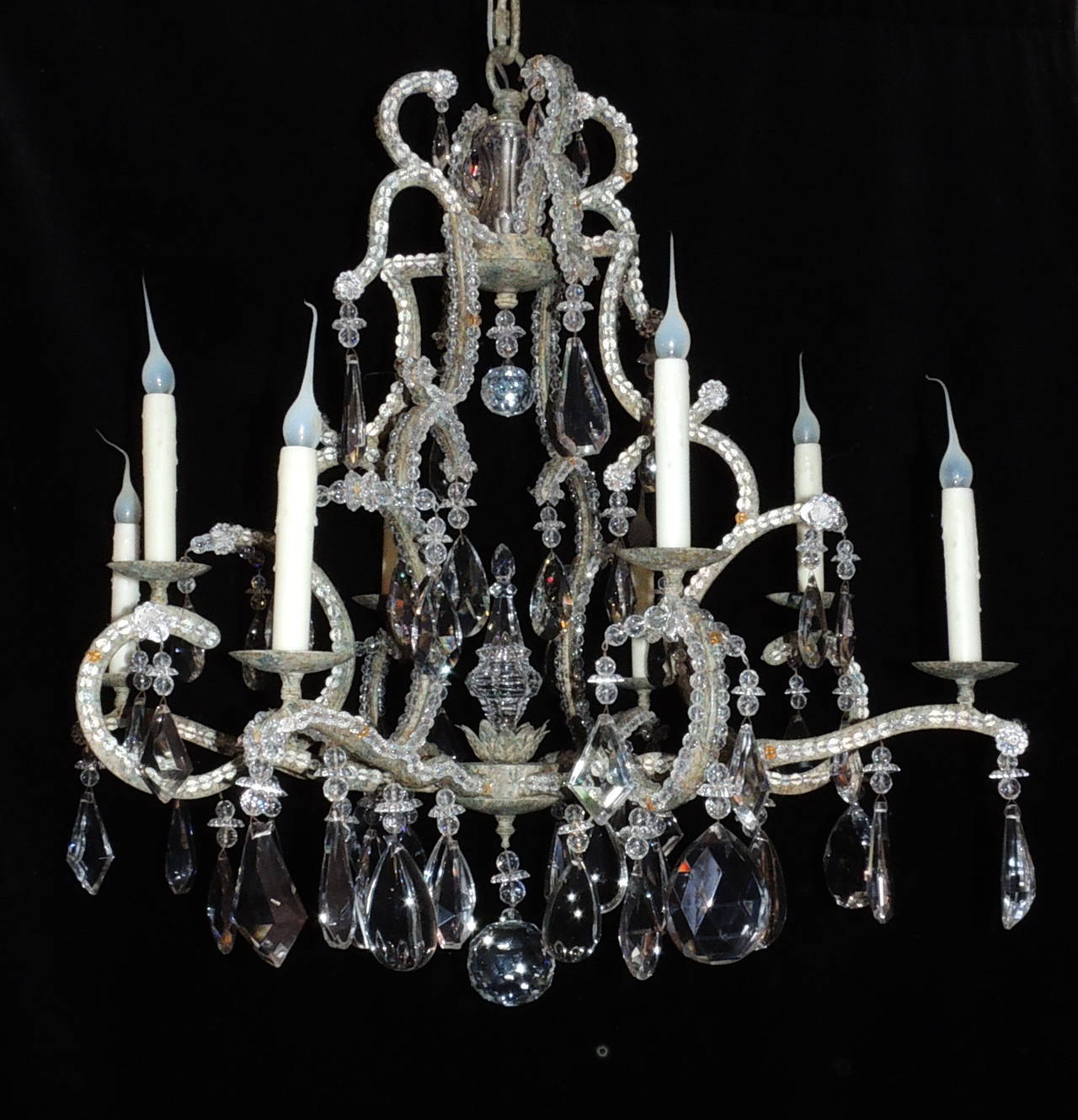 This wonderful Bagues style chandelier is a rustic finish with eight lights. The arms are trimmed with beautiful crystal beading and decorated with drop and pendeloque and almond shaped crystals, in both prism and solid forms. A fine full piece