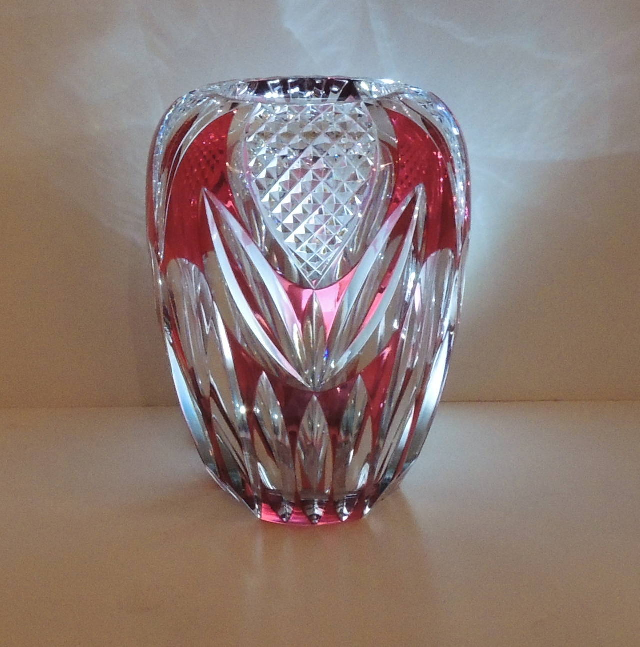 This wonderful Val St. Lambert Red Cut to Clear Cut Tulip vase is a wonderful   oval shape that will be a beautiful showpiece to put your flowers in or to add beautiful color to your shelf or table. Original label on vase and signed. From the