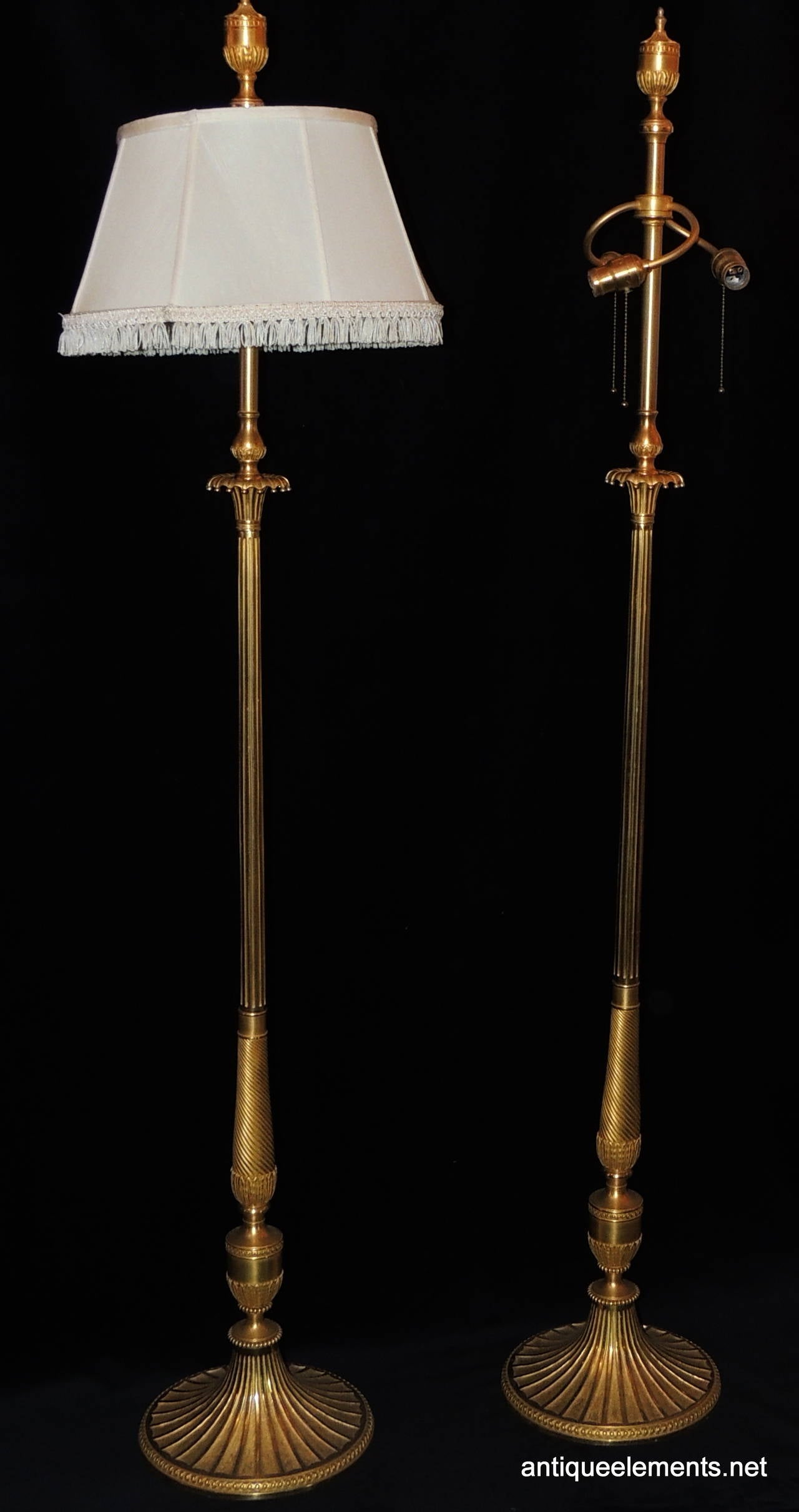 E.F. Caldwell designed this elegant pair of solid bronze floor Lamps which are beautifully detailed with architectural l elements throughout. From the beautiful finial, the fluting on the body and the beautiful etching and beaded bronze accents on