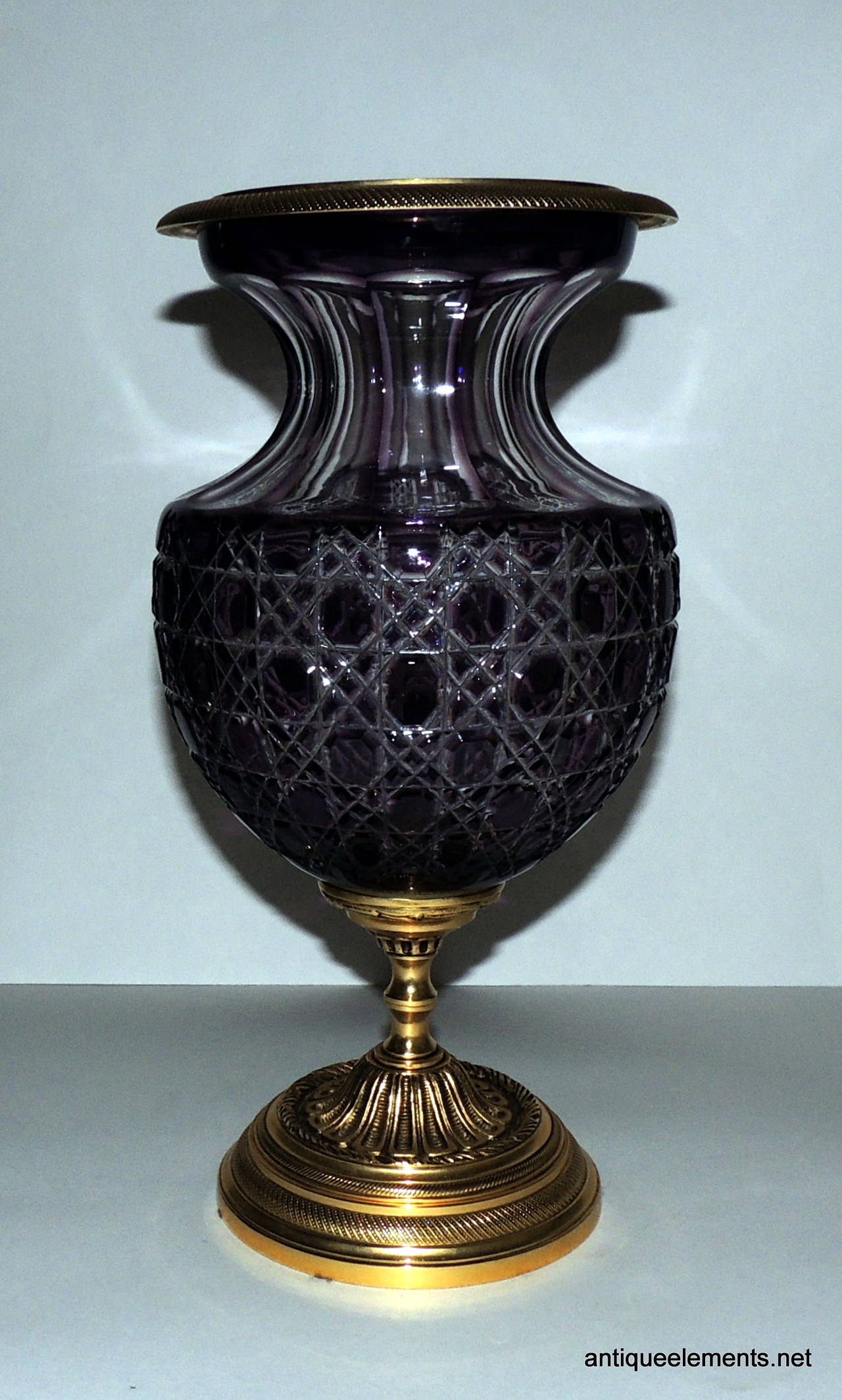 Wonderful Pair of Amethysts to Clear Cut Crystal and Gilt Bronze Vases are just the right touch for a touch of color and class.   A beautiful cut to clear cut and etched crystal pattern surrounds these wonderful vases with an elegant fluting