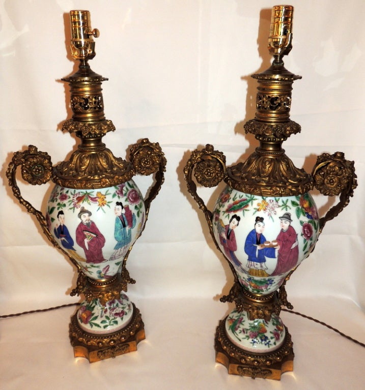 A pair of stunning French hand-painted porcelain chinoiserie lamps with ornate bronze mountings.