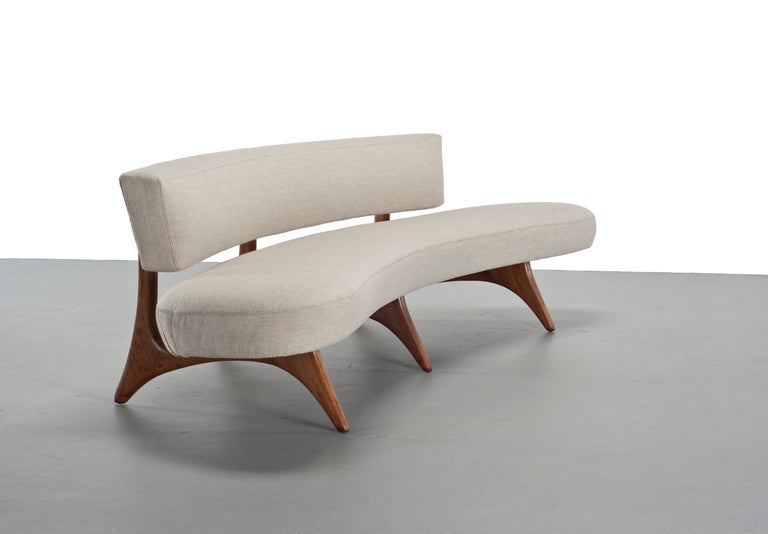 An early floating seat and back sofa, model 176SC, by Vladimir Kagan for Kagan-Dreyfuss, Inc. The sculptural walnut base is in very good original condition with minor touchups. The curved cushions have been reupholstered in beige gros point linen. A