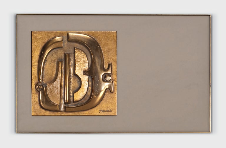 A bronze mirror with smoked glass and an inset cast bronze bas-relief sculpture by Luciano Frigerio, titled 
