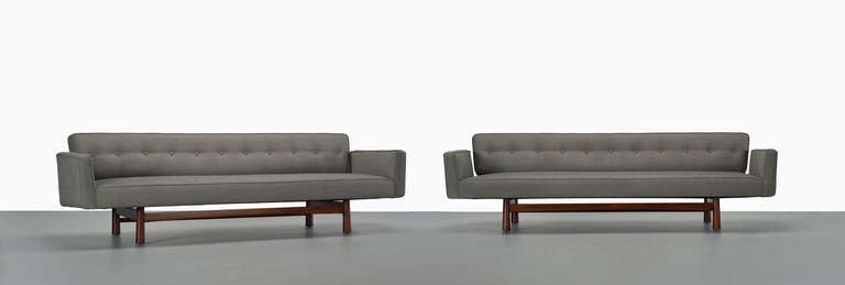 A pair of sofas, model 5316, by Edward Wormley for Dunbar. The walnut frames have a warm finish and expressive grain. The cushions are upholstered in Kvadrat Remix 133. A fabric sample is available upon request.