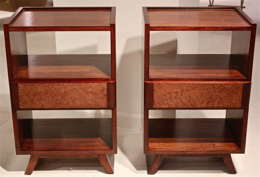 A graceful pair of mahogany and bird's-eye maple nightstands on splayed legs by Eliel Saarinen for Rway. Each nightstand features a single drawer covered in bird's-eye maple veneer with mahogany trim.