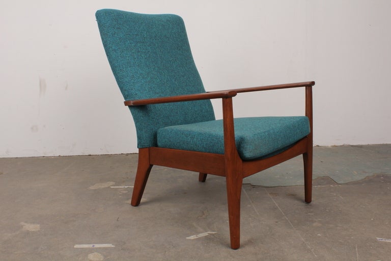 English mid century modern upholstered back, wood framed lounge chairs by Parker Knoll. Newly upholstered in a blue woven fabric and newly refinished.