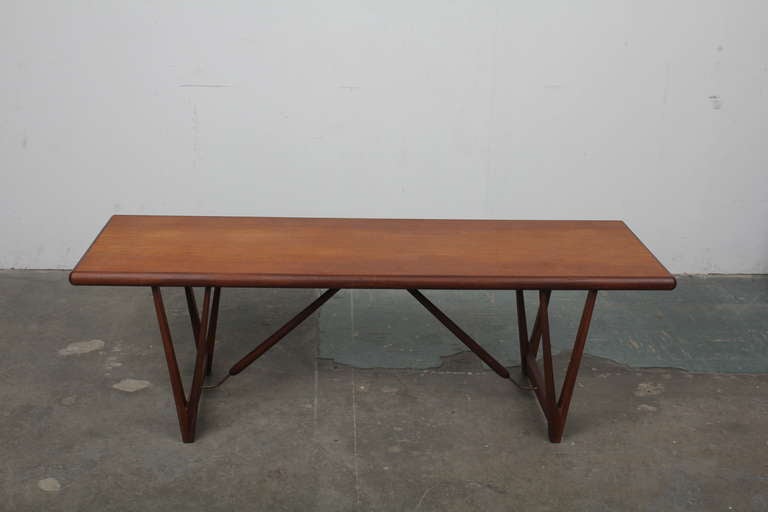 Rare and unique architectural teak coffee table with a stunning silhouette.