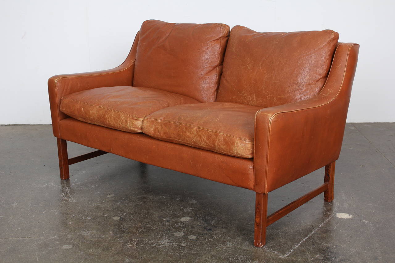Norwegian Mid-Century Loveseat in Original Brown Leather on a Rosewood Base. Model #965, designed by Fredrik Kayser for Vatne Mobler. Circa 1960.