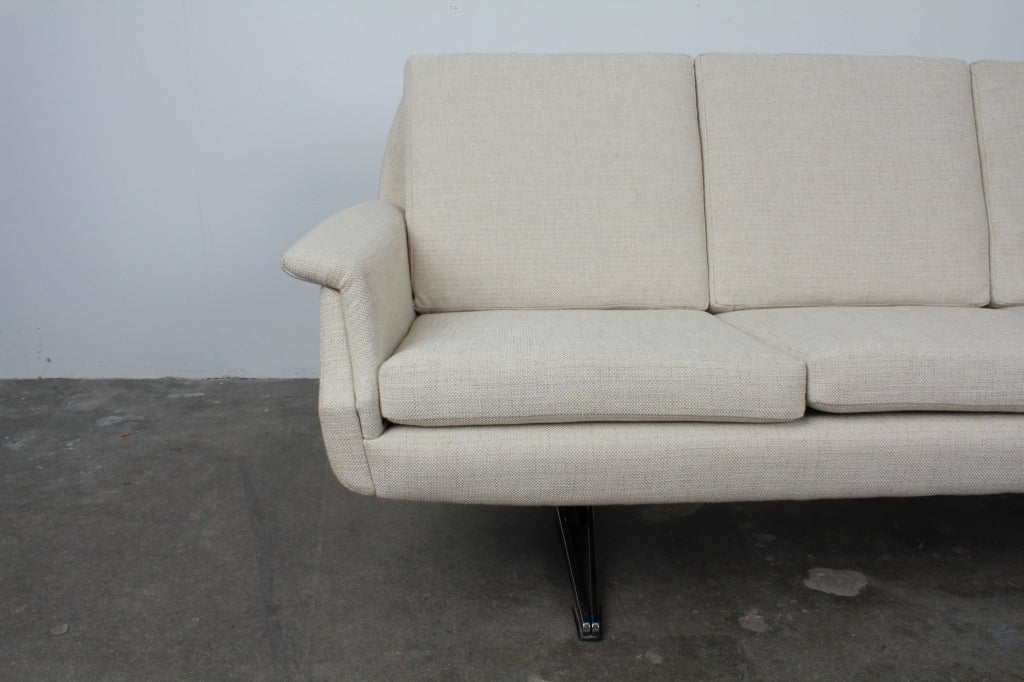 English Mid Century Modern 4 seat sofa on metal legs.