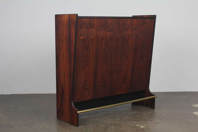 Beautiful Danish Mid-Century Modern cocktail bar by Johannes Andersen.  Double sided with rosewood inlay on the serving side, 'slate' folding top, liquor storage and mirrored serving ware storage.