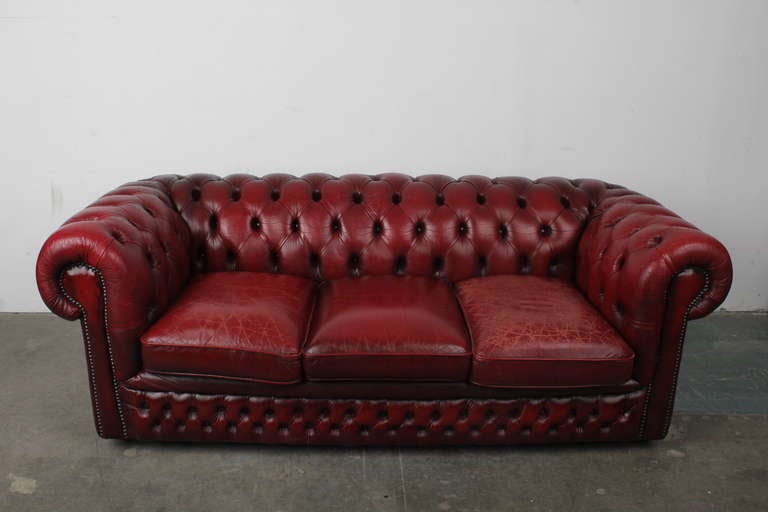 English dark red leather chesterfield sofa in excellent condition. 3 seat sofa with excellent patina, no tears or damage however.  Imported from England.