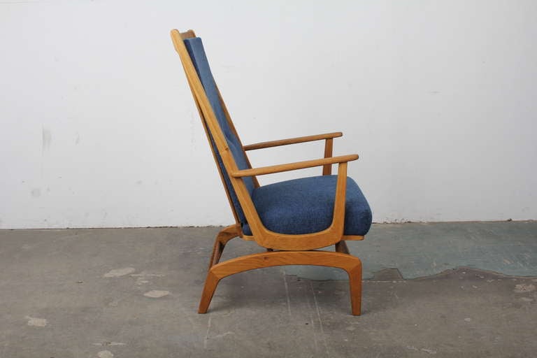Unique Danish mid century modern oak rocking chair, newly upholstered in blue fabric with button tufted back.  Rocker mechanism is built into the chair so the base remains stationary while the chair rocks on top of the base itself.