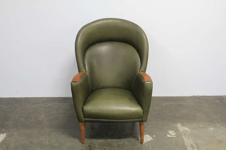 Mid-Century Modern Danish leather mid century modern lounge chair with teak arms.
