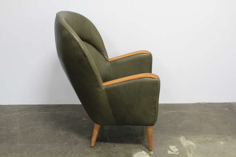 Mid-20th Century Danish leather mid century modern lounge chair with teak arms.