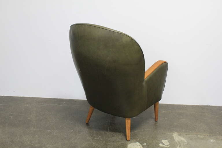 Danish leather mid century modern lounge chair with teak arms. 1