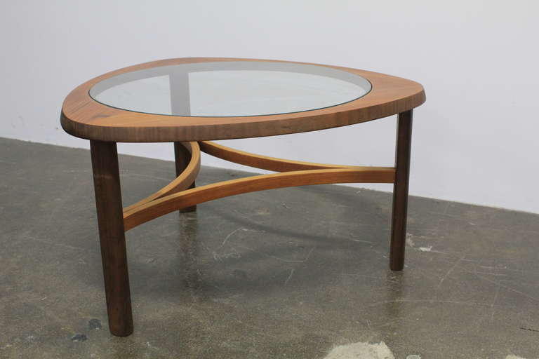 Mid-Century Modern English mid century modern rounded glass top and teak coffee table.