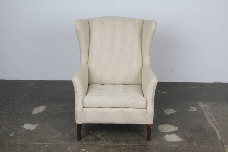 Modern and sophisticated wingback chair beautifully reupholstered in an incredible (pattern) wool with tufted seat detail. 

Comfortable and truly stunning.