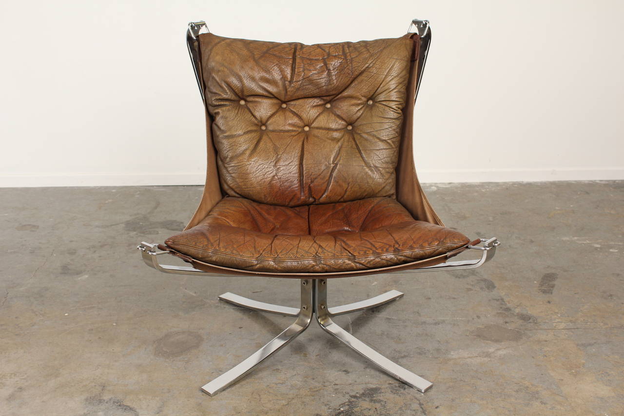 Absolutely incredible Falcon Chair by Sigurd Resell.  The original light brown vintage leather is truly stunning and some of the best patina we've seen.  A true conversation piece that's also incredibly comfortable.  Sturdy and sculptural chrome