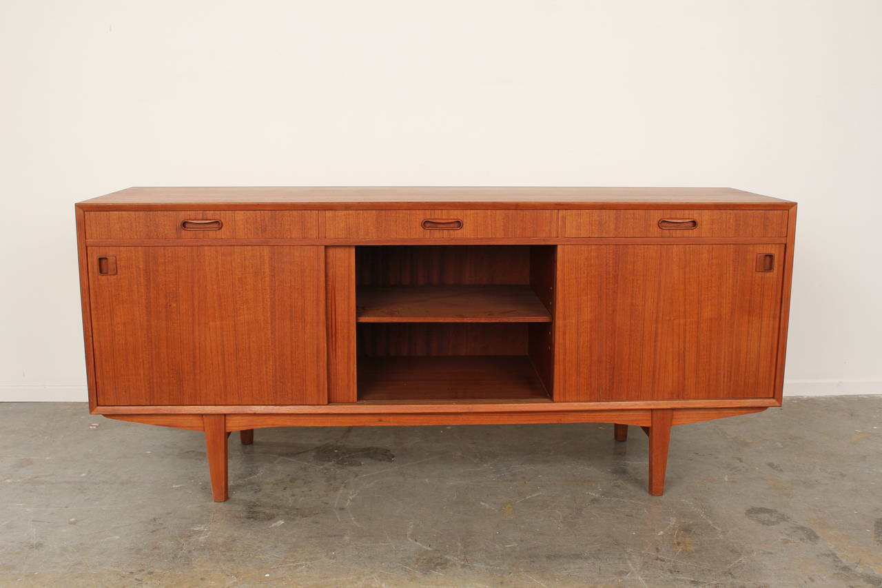 Fantastic teak sideboard made in Denmark circa 1960's.  Completely refinished with hand-rubbed oil to keep the teak in it's most beautiful and natural state.