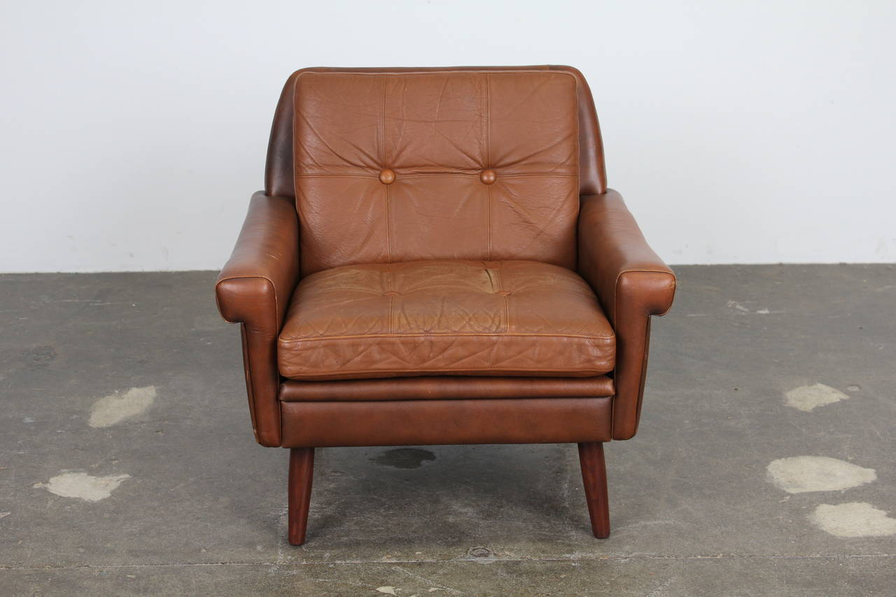Danish Mid-Century Modern Low Lounge Chair by Skipper Mobler.  Brown vintage leather with tufted back and seat cushions, with nice patina. Sits on tapering solid teak legs.