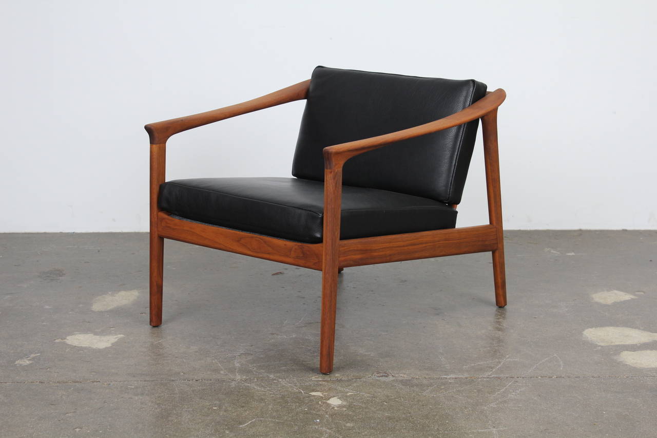 Solid teak and black leather lougne chair by Folke Ohlsson for Dux 2