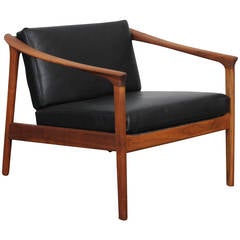 Solid teak and black leather lougne chair by Folke Ohlsson for Dux