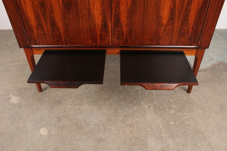 Beautiful and hard to find Danish mid century modern rosewood tambour door bar with dual pull out drink preparation slates. Designed by Kurt Ostervig, produced by CFC Silkeborg.