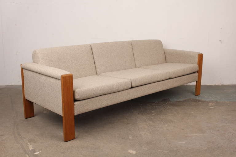 Danish modern 3 seat sofa newly upholstered.  Oak legs frame the sofa with clean lines.