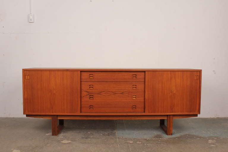 Danish modern teak sideboard with newly produced sleigh legs.  The legs have beautifully detailed dovetail joinery.