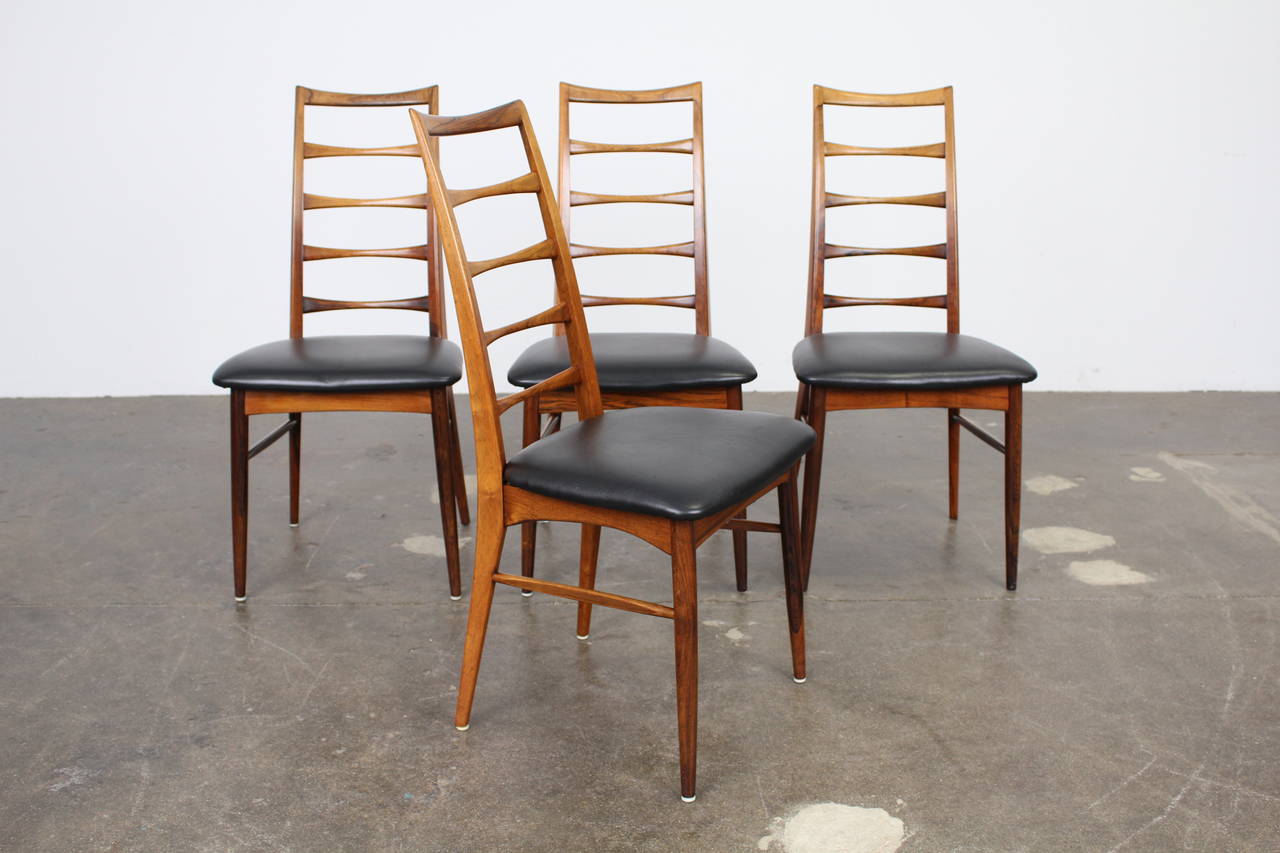 Four extremely rare and exquisitely sculpted tall ladder back rosewood dining chairs designed by Niels O. Moller for Koefoeds Hornslet. Newly upholstered in black leather. The chairs have excellent grain throughout.