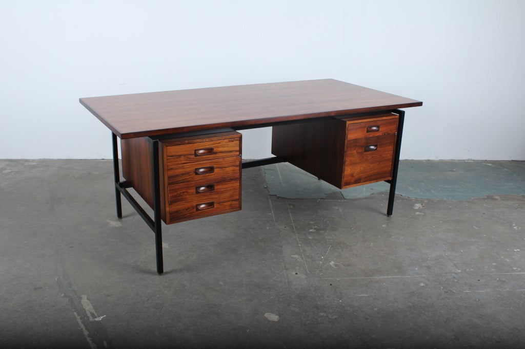 Mid century modern Danish rosewood desk with black metal frame/legs.  Left side bank of 4 drawers and right side drawer with hanging file drawer.  Newly refinished in lacquer.
