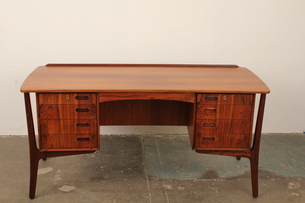 Danish mid century modern 8 drawer executive desk by Svend Aage Madsen, produced by H.P. Hansen. Beautiful grain, back storage and locking cabinet highlight this superb desk.